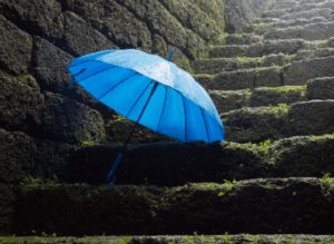 blue umbrella on old stone steps
